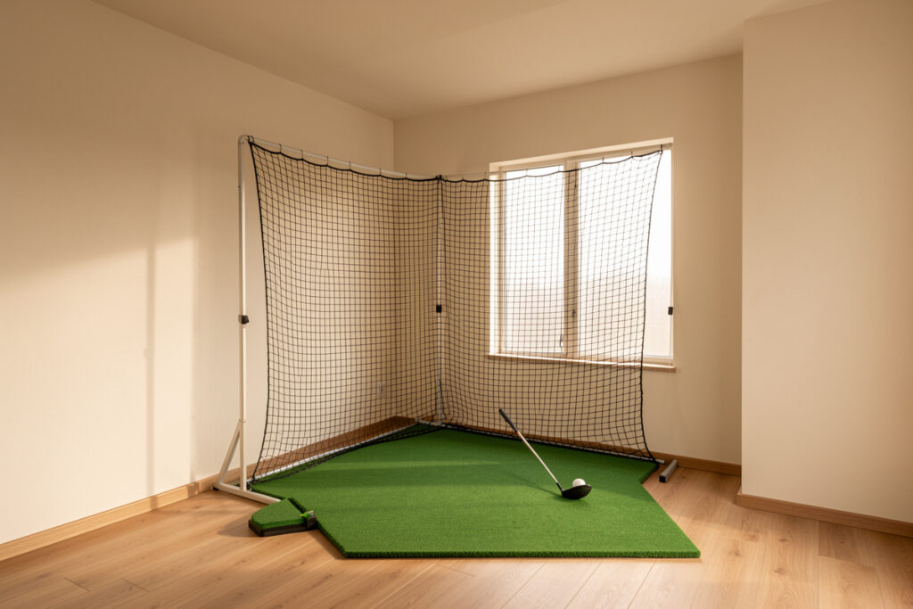 Apartment corner converted into a compact golf net practice station under a low ceiling