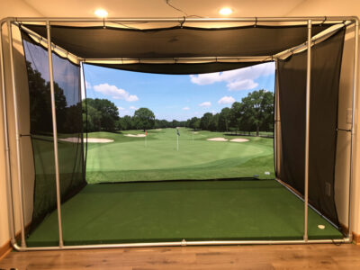 DIY framed mid-range golf simulator enclosure with a commercial impact screen