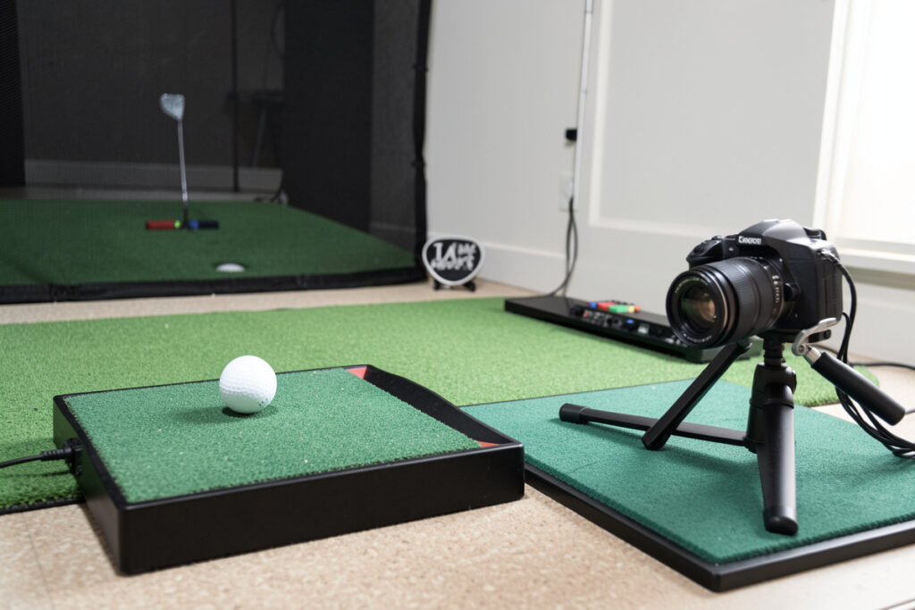 Radar and photometric budget golf launch monitors compared side by side in a home sim room