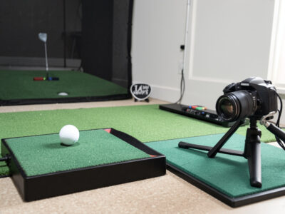 Radar and photometric budget golf launch monitors compared side by side in a home sim room