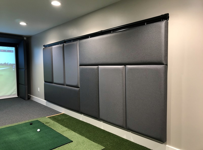High-impact foam wall padding panels installed on the side wall of a home golf simulator room